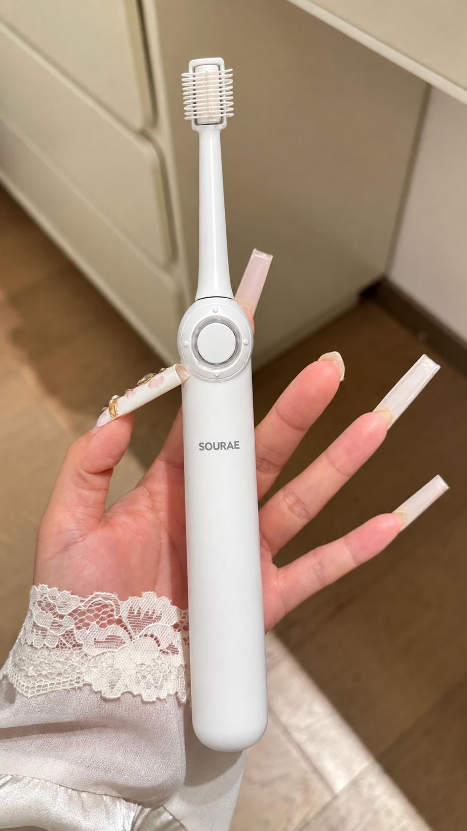 Brosse Sourae blanche tenue en main